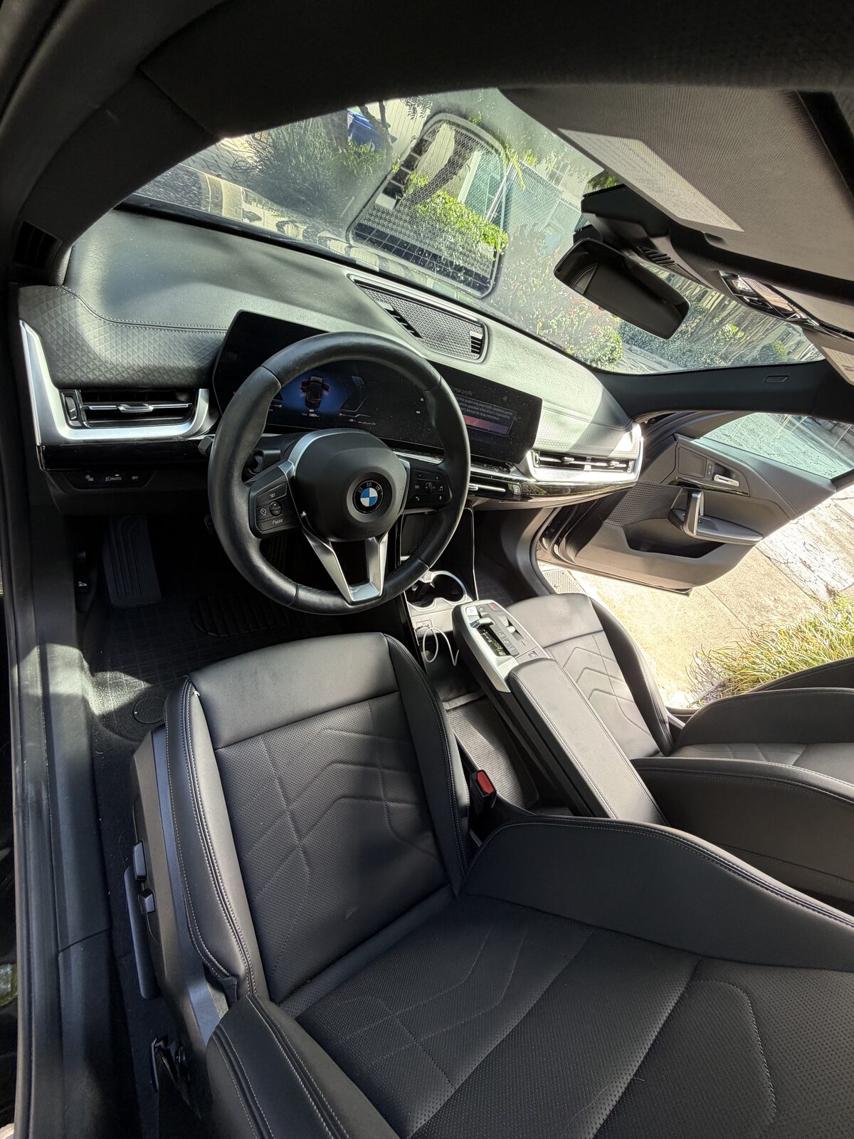 BMW — front interior detail, carbon dash and black leather